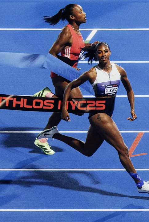 Two sprinters racing to the finish tape at ATHLOS NYC 2025